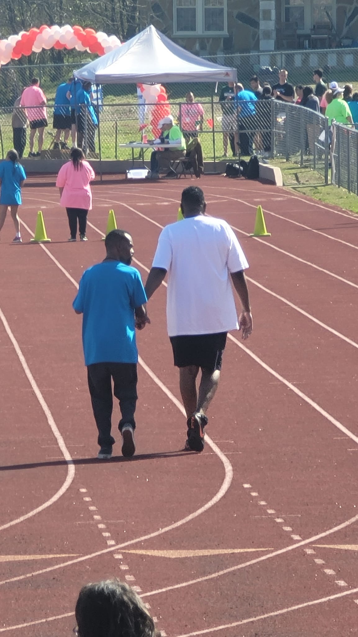 two men walking on a track