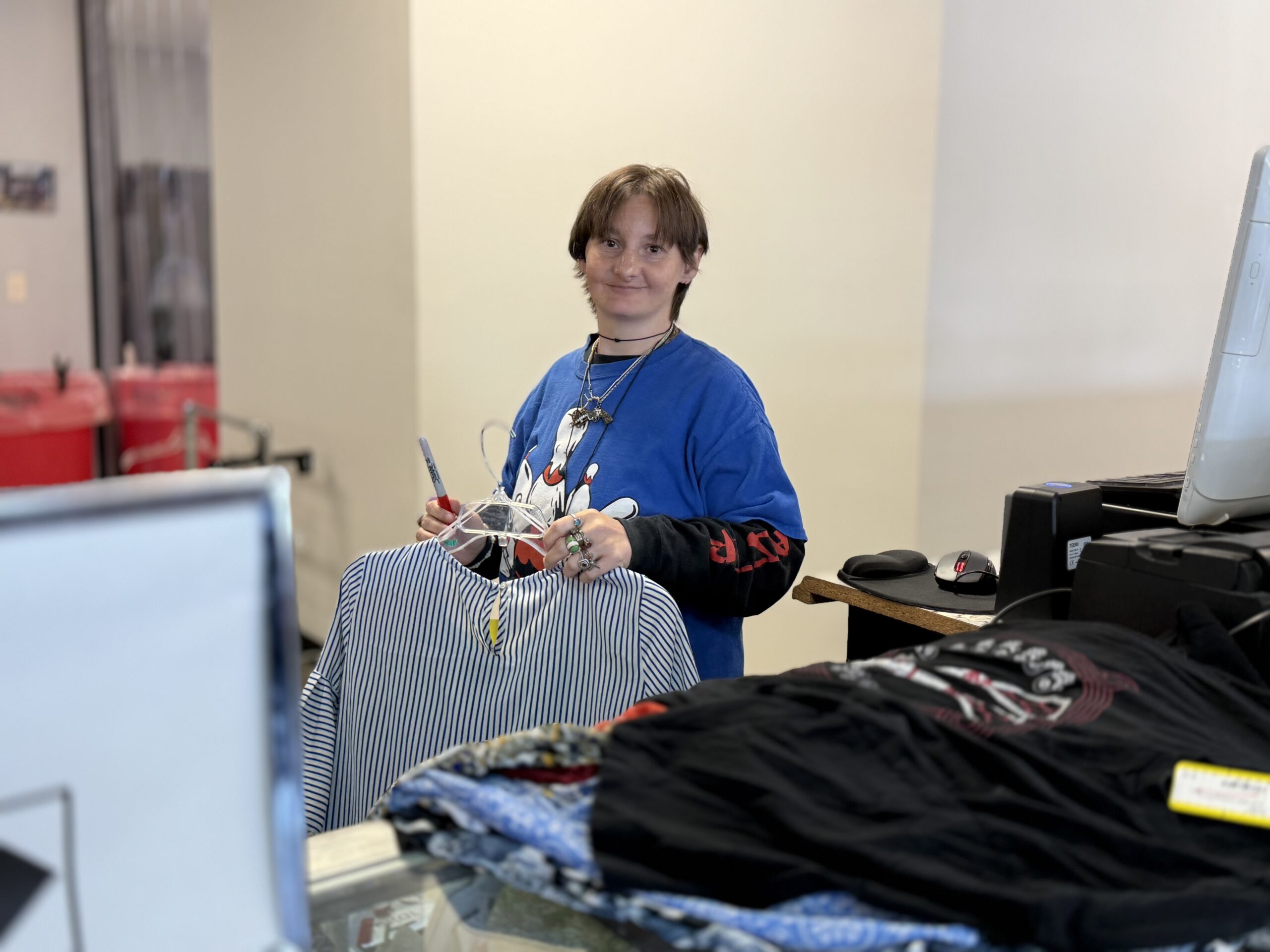 person holding clothes and preparing to hang them up