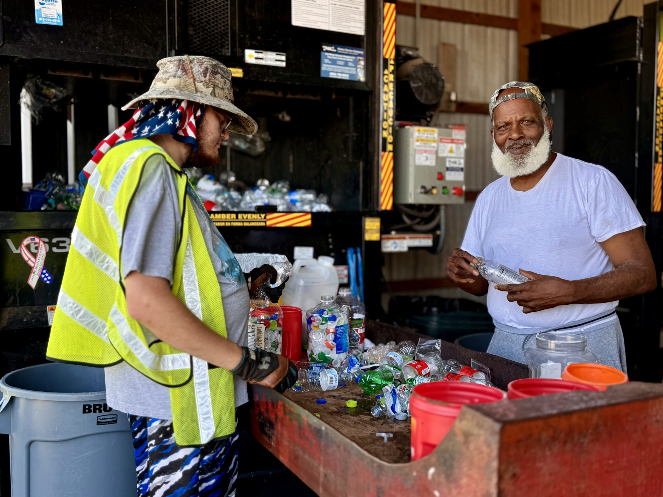 two men recycling plastic